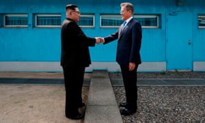 North Korea’s leader Kim Jong Un (L) shakes hands with South Korea’s President Moon Jae-in (R) at the Military Demarcation Line that divides their countries ahead of a summit in April 2018.
