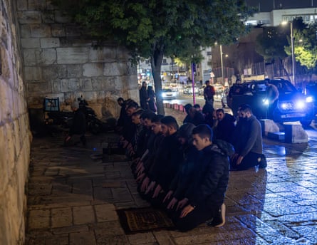 Palestinians gather outside the Old City walls to pray in protest of the closure of al-Aqsa mosque.