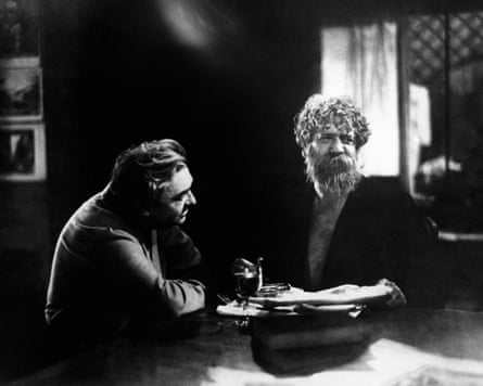 Two men sit at a table