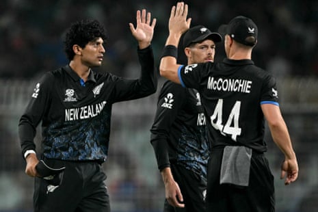 New Zealand's Rachin Ravindra celebrates with teammates after taking the wicket of David Miller.