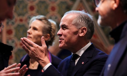 Carney next to his wife, Diana Fox Carney, at Notre Dame Cathedral in Paris