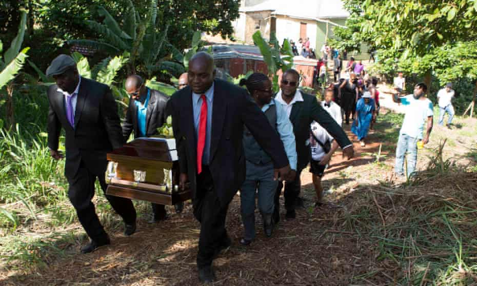 Finding peace: family members carry the coffin of Mzee Mohammed to its final resting place in Mandeville, Jamaica. 