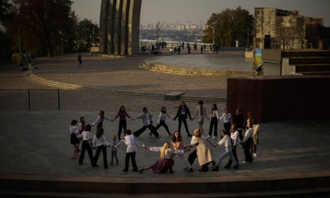 Youngsters play a group game at the Arch of Freedom of the Ukrainian people square in Kyiv, Ukraine.