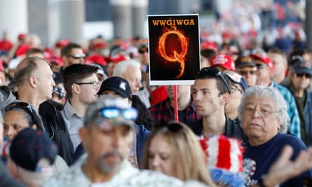 A man in the crowd holds a QAnon sign as crowds gather to attend Donald Trump’s campaign rally in Las Vegas, Nevada, 21 February 2020.