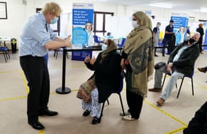 Batley, UK: Boris Johnson puts his thumbs up at patients after they were given the Covid-19 jab during a visit to a vaccination centre in West Yorkshire