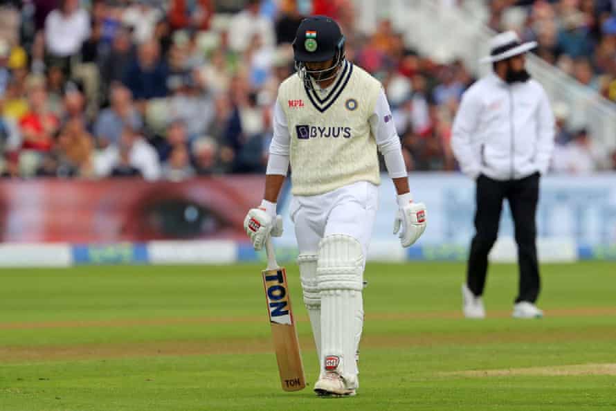 Shardul Thakur walks back to the pavilion after losing his wicket for four runs.