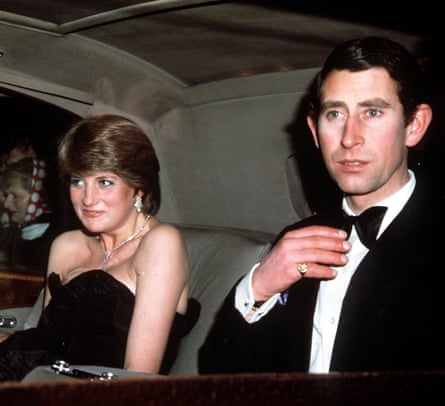 Diana with short hair and black strapless dress with Charles in bow tie and black suit