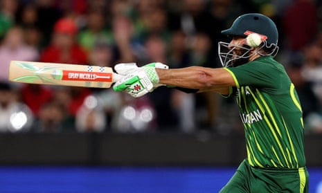 Pakistan's Shan Masood is hit by a ball on the helmet.