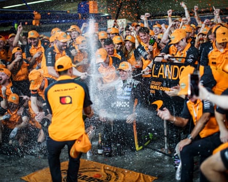 Lando Norris sprays champagne astatine McLaren’s paddock staff.