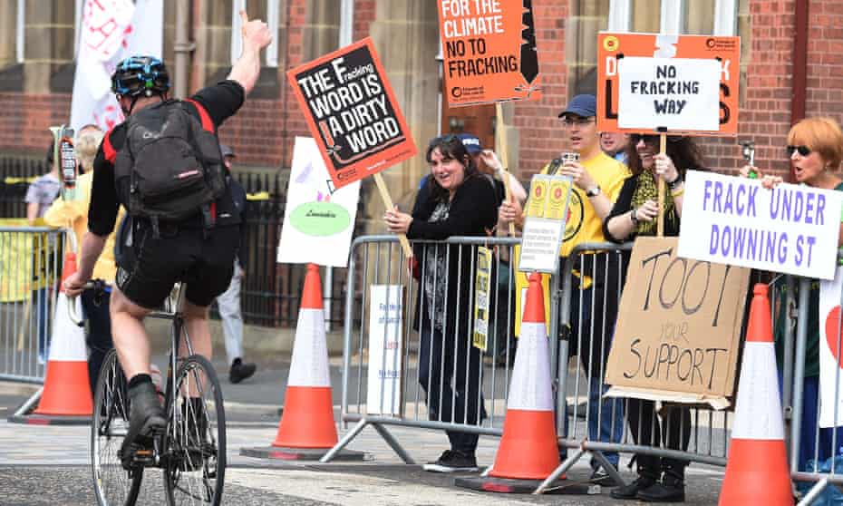 A cyclist shows his support to protesters at County Hall in Preston. The report’s release comes days after Lancashire council rejected the UK’s biggest fracking bids so far. 
