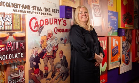 Louise Stigant, UK managing director of Mondelez, at the Cadbury factory in Bournville, Birmingham. She standing against a display of vintage Cadbury's chocolate posters