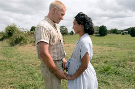 Joel Edgerton and Ruth Negga holding hands and looking into each other’s eyes in Loving