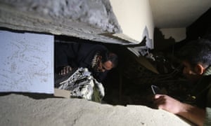Iraqis search for people trapped in collapsed buildings in Sulaymaniyah.