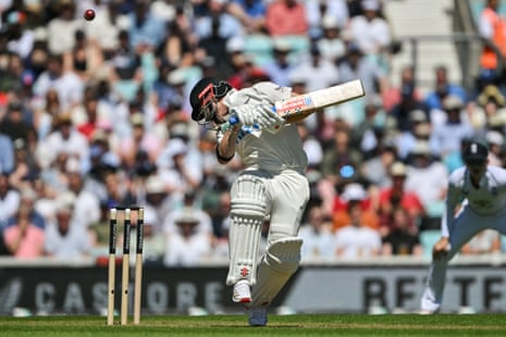 New Zealand's Henry Nicholls avoids a bouncer from a ball by England's Josh Tongue .