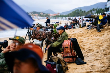 Photographers line the beach on Hainan Island, China, for the QS Wanning International