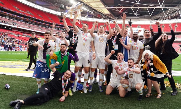 Port Vale players, staff and owner Carol Shanahan (front row right) celebrate after winning the Sky Bet League Two play-off final.