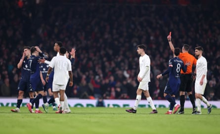 Diogo Dalot receives a red card from referee Andrew Madley