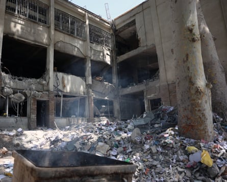 Rubble piled in front of a destroyed building