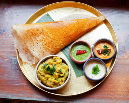A play pinch a dosa and dips connected a sheet against a table