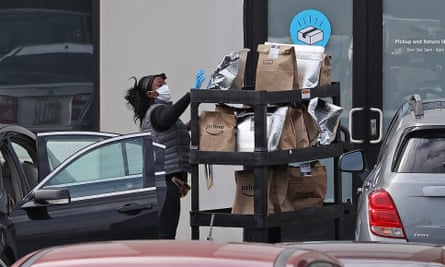 An Amazon Flex driver loads their personal vehicle with packages outside the 1.2 million-square-foot Amazon Fulfillment Center in Baltimore, Maryland.