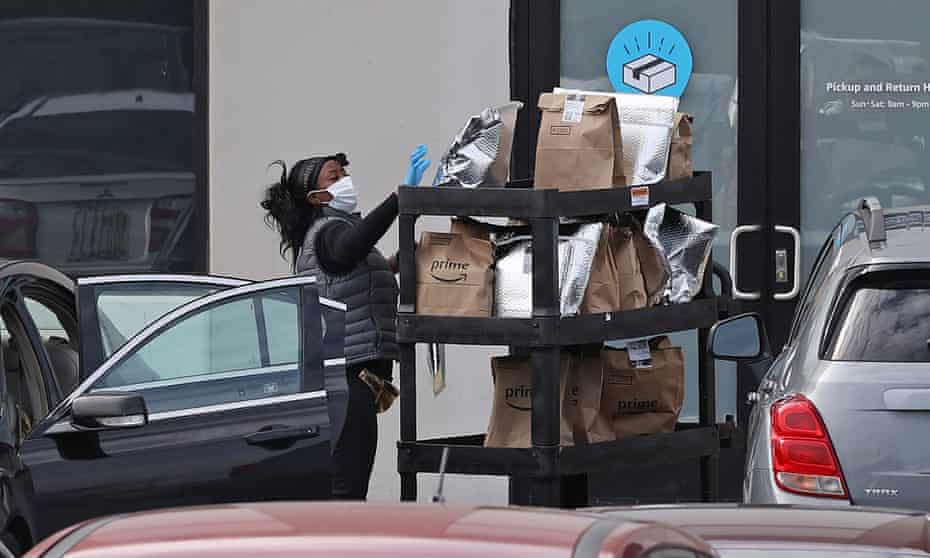 An Amazon Flex driver loads her personal vehicle with packages outside the 1.2m sq ft BWI2 Amazon fulfillment center in Baltimore, Maryland.
