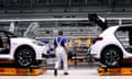 A Volkswagen employee  works on an assembly line to produce the Volkswagen ID.3 electric car