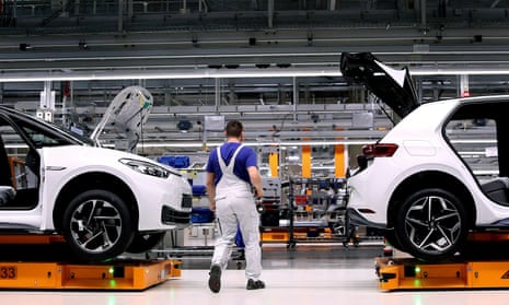 A Volkswagen employee works on an assembly line to produce the Volkswagen ID.3 electric car