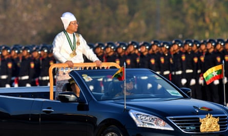 Myanmar’s military chief and junta leader Min Aung Hlaing stands in a car as he oversees a military display at a parade ground to mark the country’s Independence Day in Naypyidaw on 4 January 2023.