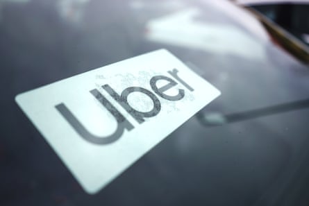 An Uber sticker on a car windscreen.