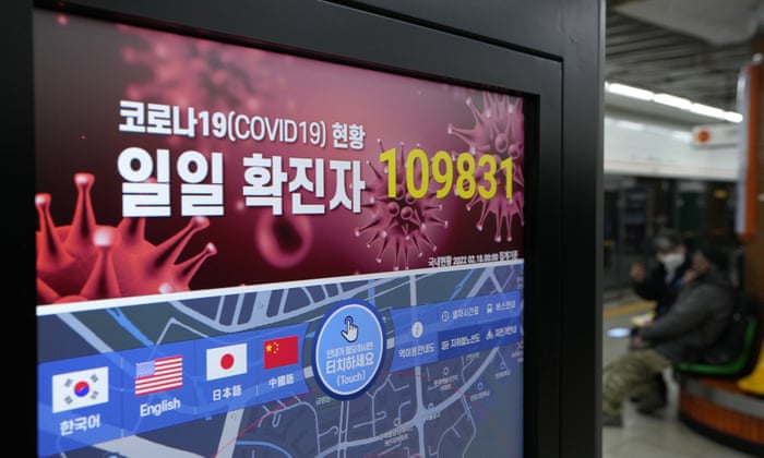 A screen shows the number of new coronavirus infections nationwide at a subway station in Seoul.