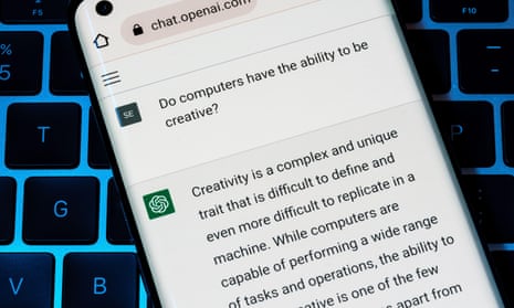 OPEN AI ChatGPT chat bot seen on smartphone placed on laptop