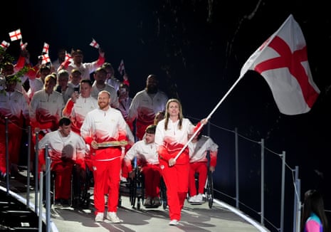 Sian Honnor, flag bearer of England alongside Luke Greenbank, baton bearer leads their delegation during the opening ceremony.