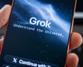 hand holds phone screen showing Grok app