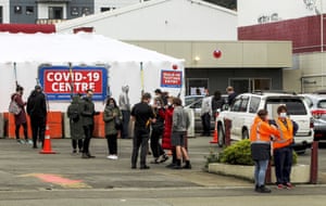 People queue outside a COVID-19 testing station in central Wellington, New Zealand, Wednesday, June, 23, 2021.