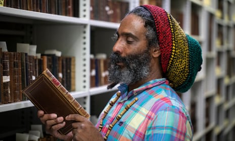 Graham Campbell looking at a book in a library