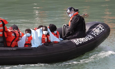 Children in inflatable boat with blankets and lifejackets