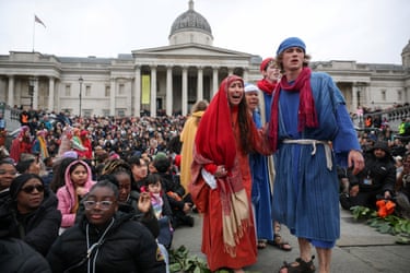 Image 11: Actors in robes surrounded by a big crowd