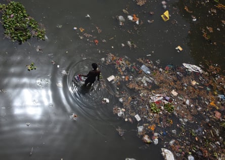 A man looks for recyclable items on the banks of the Yamuna, on the outskirts of New Delhi.