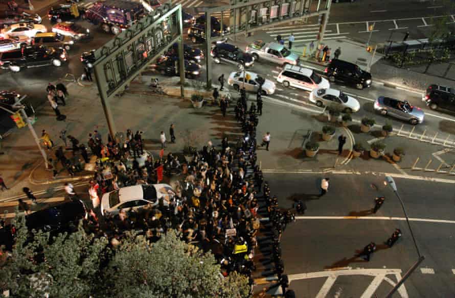 Demonstrators face off against New York police officers as they try to block an entrance to the Holland Tunnel.