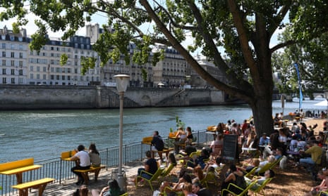 People sit by the Seine during the annual Paris Plages  summer event in Paris