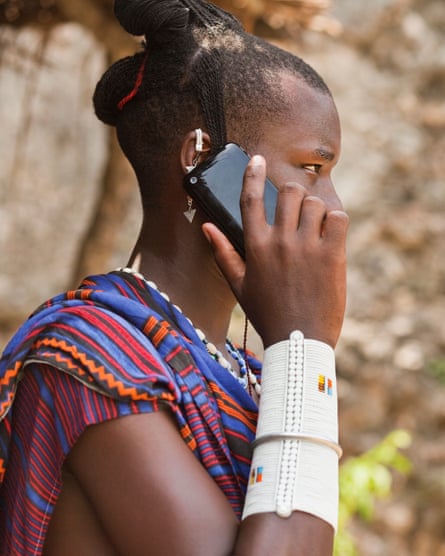 A Maasai man using a smartphone