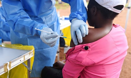 A health worker administers Ebola vaccine to a woman in the Democratic Republic of the Congo