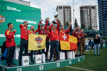 FK Khrestonostsi on the podium holding the cup aloft