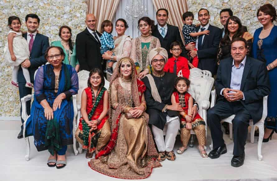 Saima (back row, centre, holding her son, Ben) at her cousin’s wedding, September 2015. Mir’s parents sit at either end, front row; back row: her sister Javaria (third left), brothers Zafar and Khizer (8th and 10th from left), and sisters Fozia and Khola (far right).