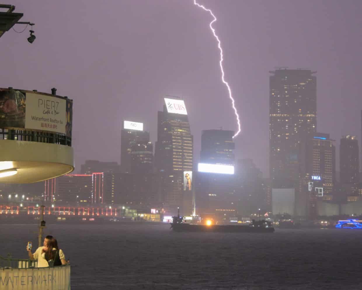 A bolt of lightning streaks across the night sky over Hong Kong