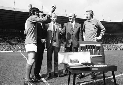 George Best holds up the Ballon d'Or as Bobby Charlton, Denis Law and Matt Busby look on