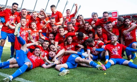 Heidenheim players celebrate after securing promotion with two goals in stoppage time.