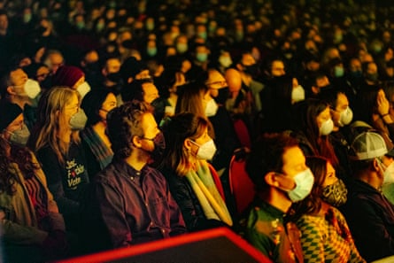 Crowd wears masks