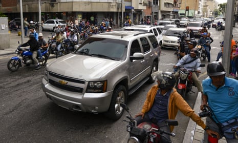 Journalists on motorbikes follow a caravan of opposition lawmakers on their way to the National Assembly in Caracas, Venezuela, Wednesday, Jan. 15, 2020. The caravan returned to an opposition headquarter after government supporters hurl stones at the vehicles. (AP Photo/Matias Delacroix)
