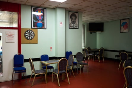 Chairs and tables, and a dartboard on the wall